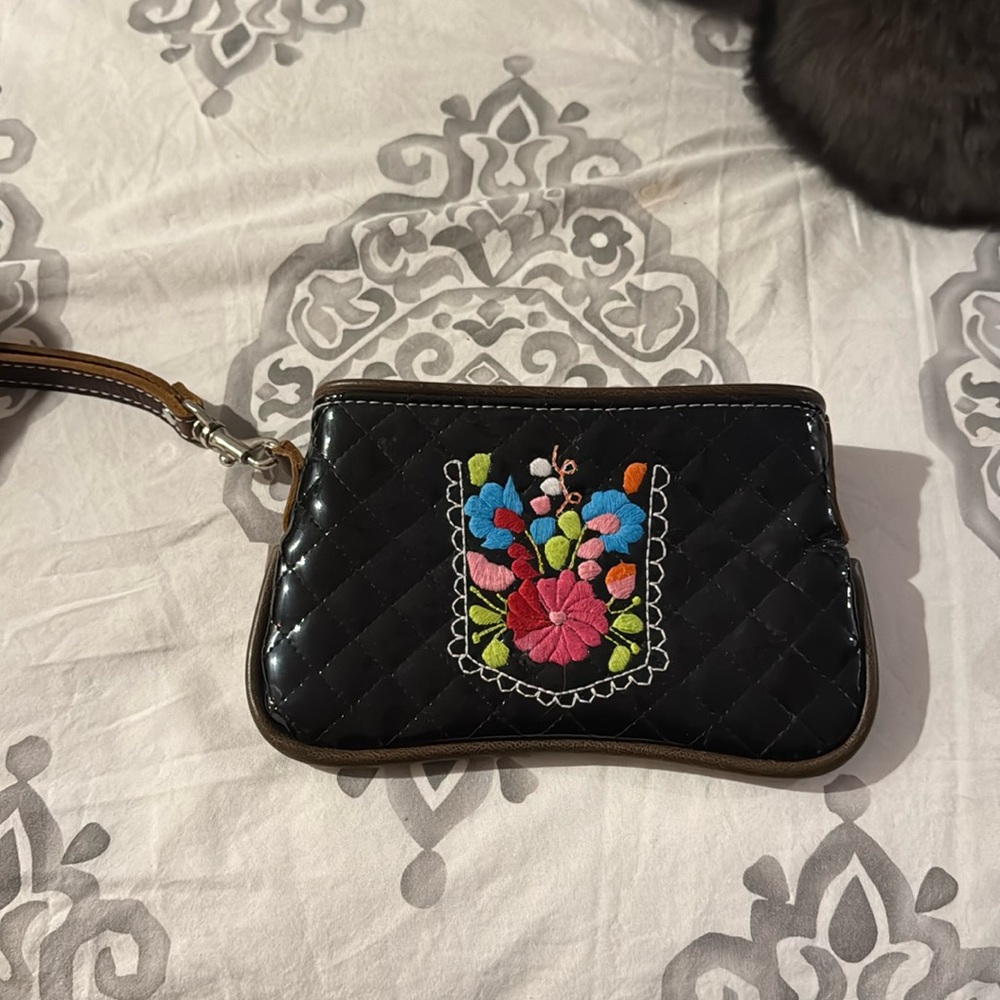 Adorable quilted patent leather wristlet with embroidery design.
